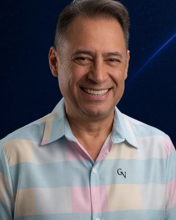 Dr. Gian C. Villatoro smiling, in a light pastel shirt, against a navy background